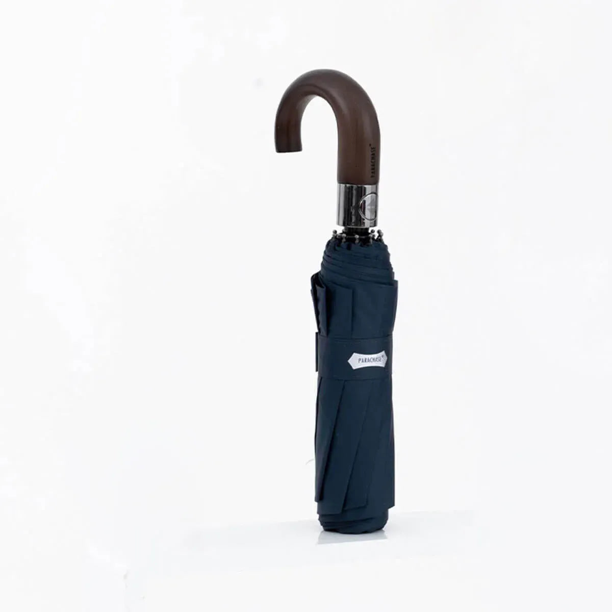 The automatic folding umbrella with a wooden hook handle, shown closed in a sophisticated navy blue color.
