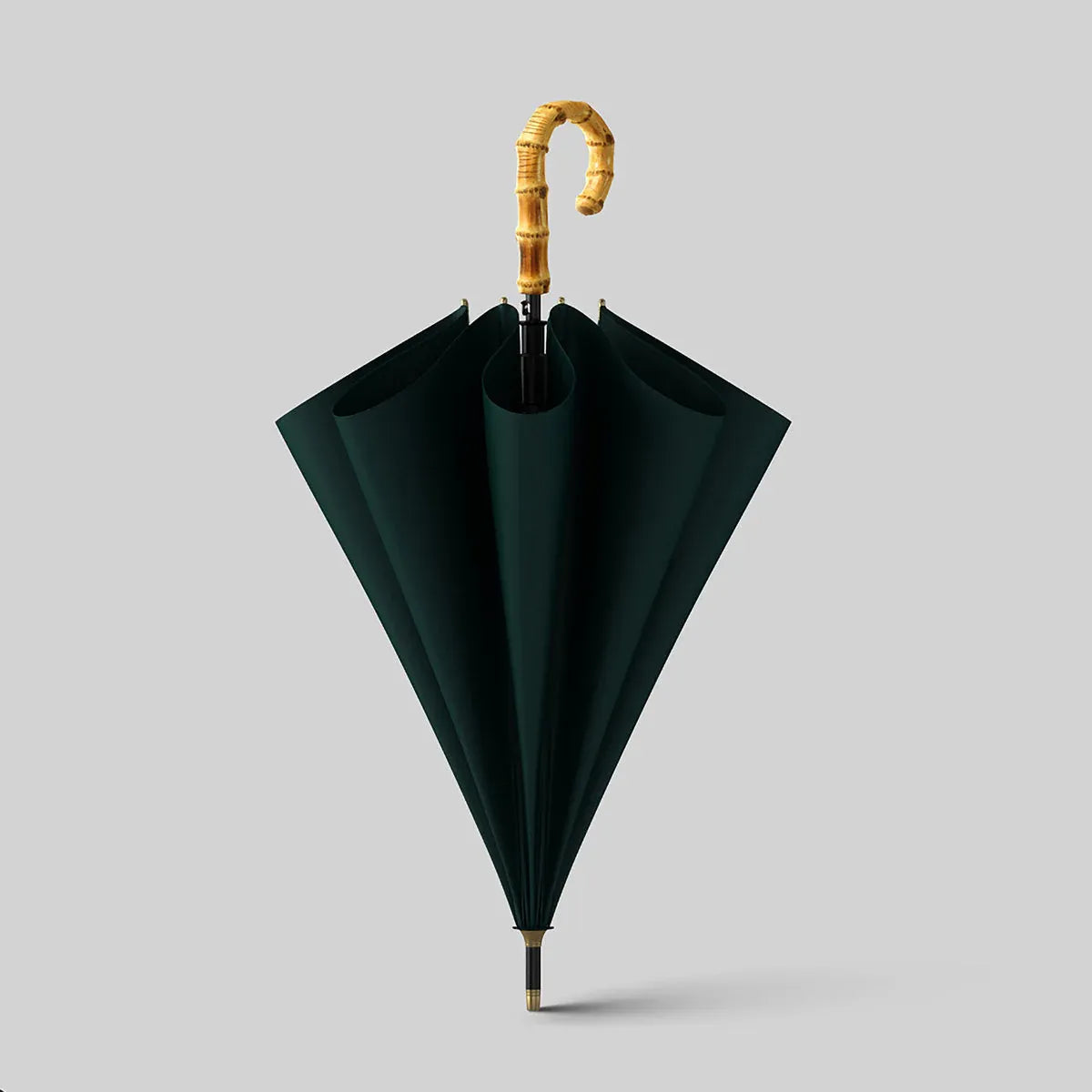 The classic stick umbrella with an authentic bamboo crook handle, shown in a sophisticated dark green color.