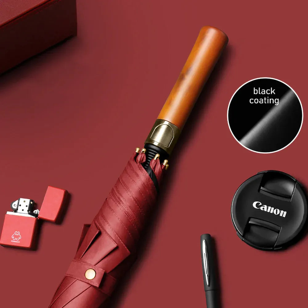 The long stick umbrella with a straight wooden handle in red, highlighting the black coating.