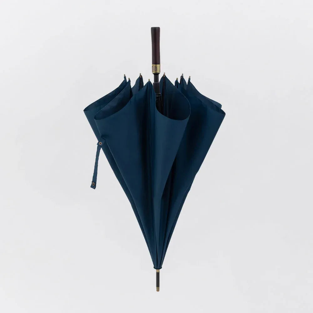 The premium big rain umbrella with a straight wood handle, shown closed in sophisticated navy blue.