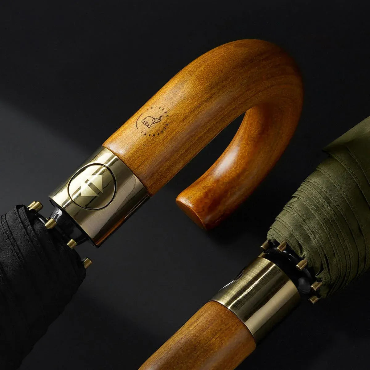 Elegant umbrellas with curved wooden handles and brass accents in black and olive colors