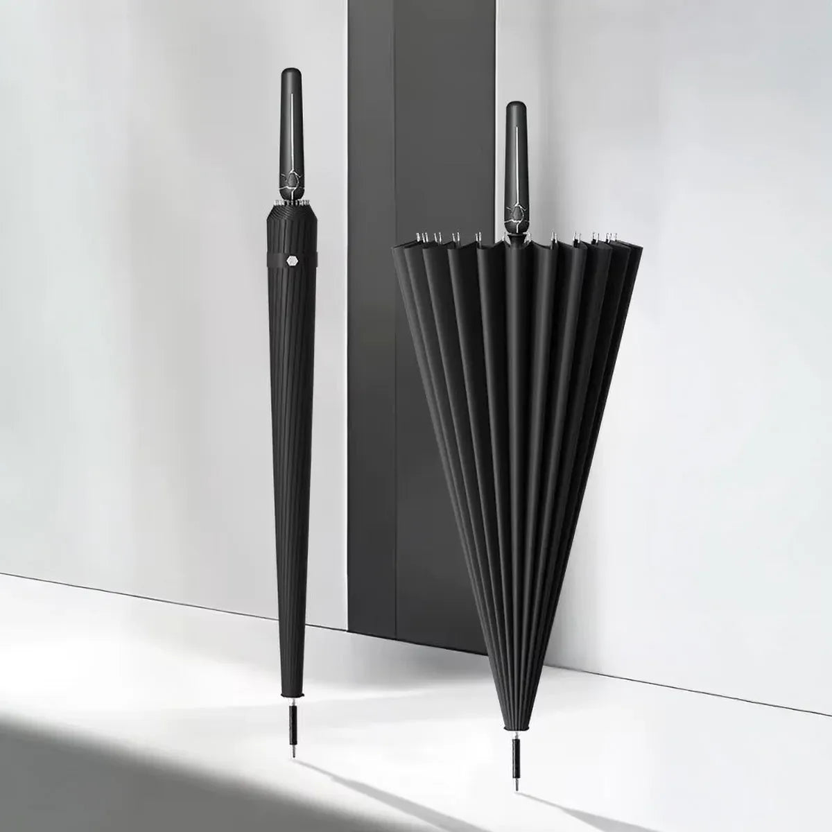 Minimalist shot of the black 24-rib auto-open umbrella, showing both open and closed views side-by-side.