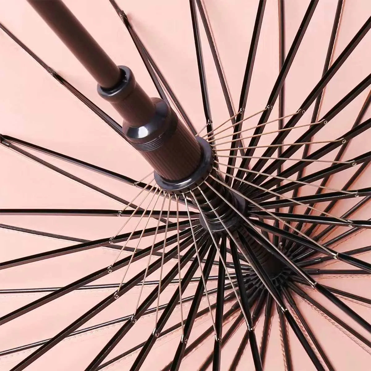 View from underneath the pink 24-rib ladies umbrella, showing the strong black fiberglass frame.