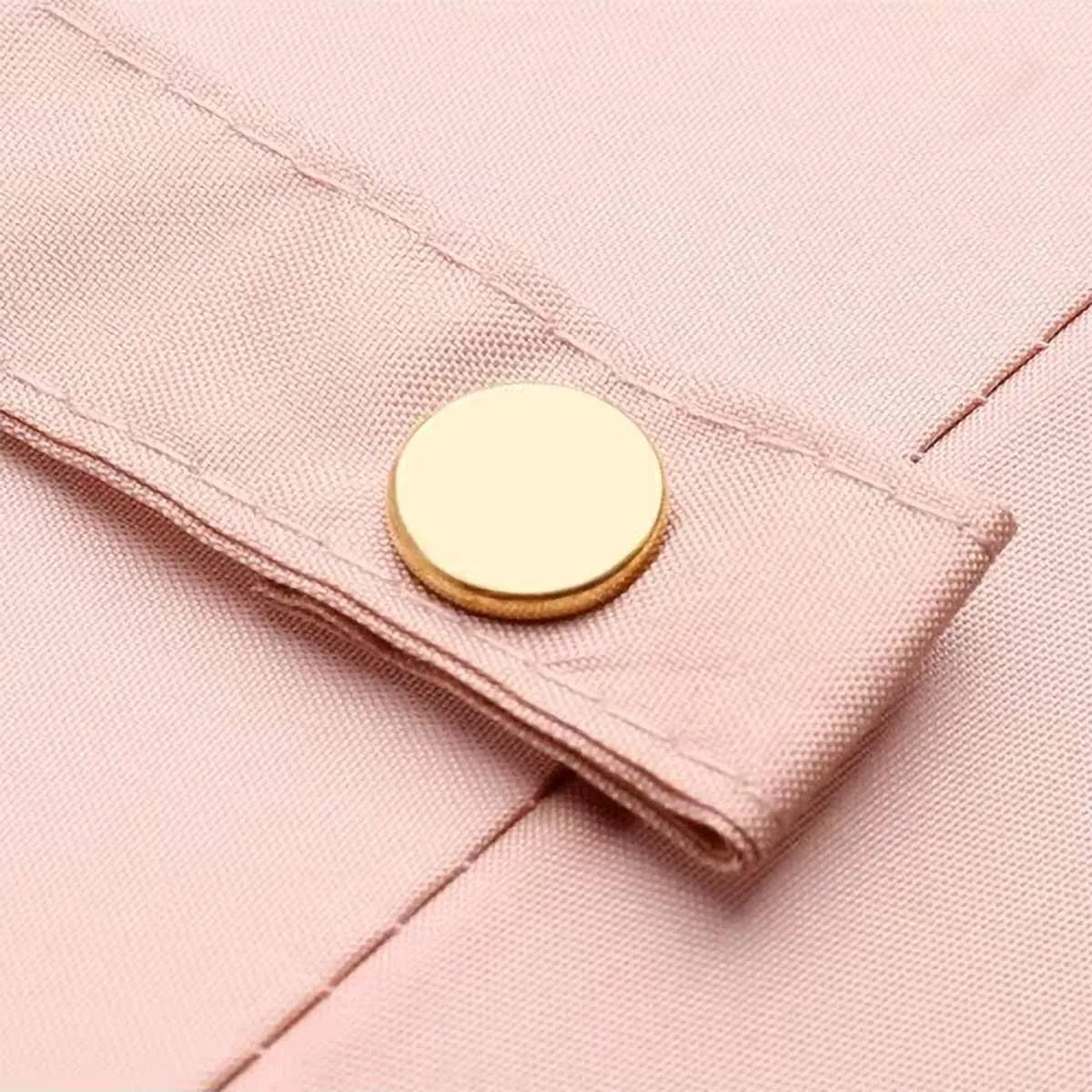 Close-up of the elegant gold snap button on the closure strap of the pink 24-rib ladies umbrella.