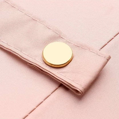 Close-up of the elegant gold snap button on the closure strap of the pink 24-rib ladies umbrella.