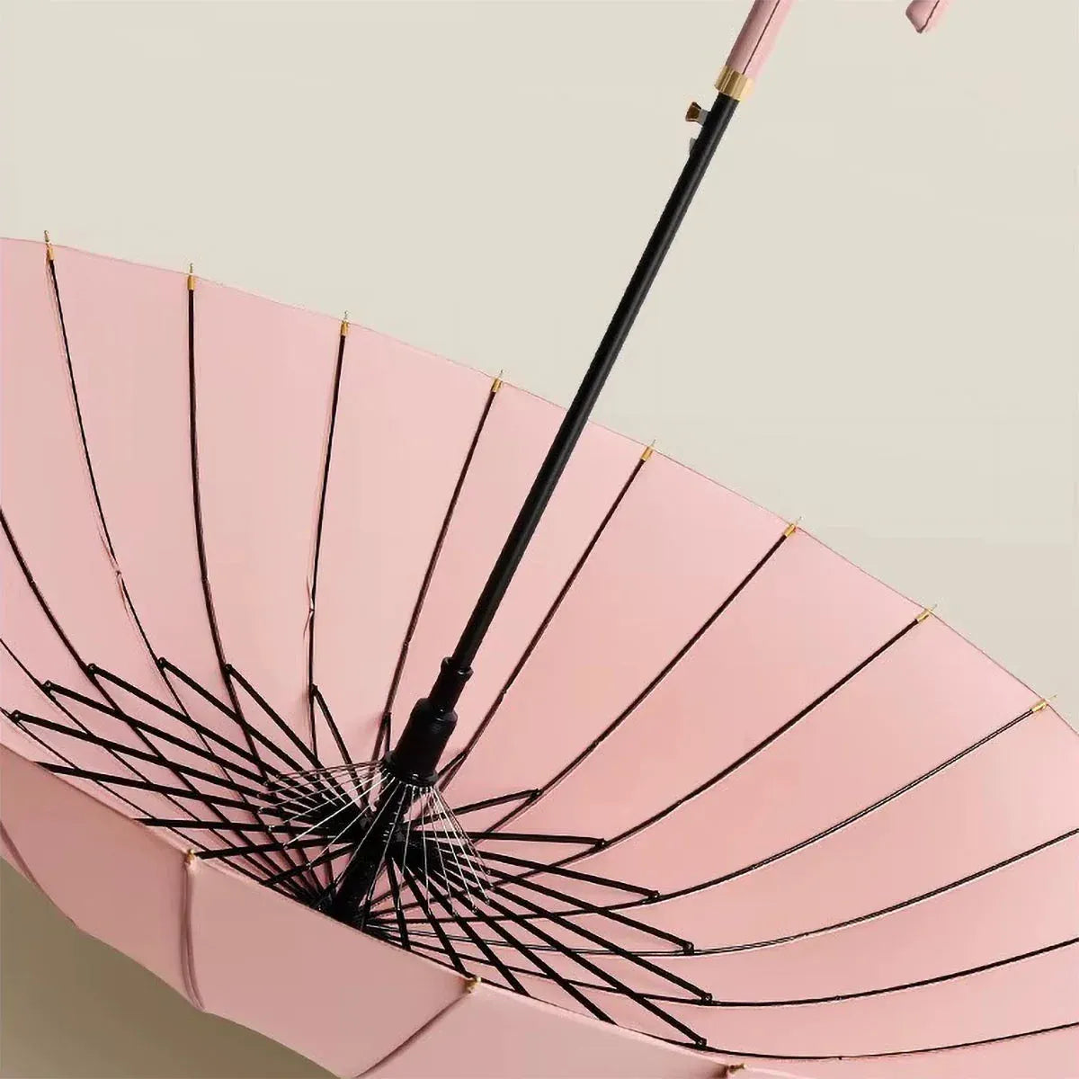 Angled view of the open pink canopy on the 24-rib ladies umbrella, highlighting the fiberglass structure.