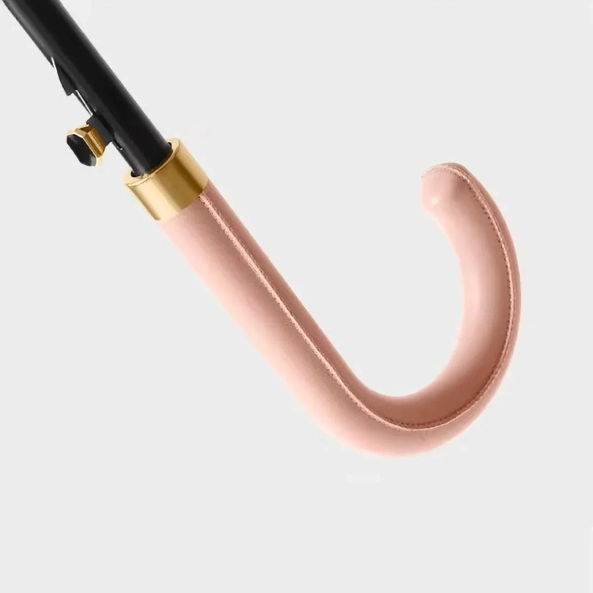 Detailed close-up of the stitched pink leather crook handle and gold accents on the 24-rib storm umbrella.