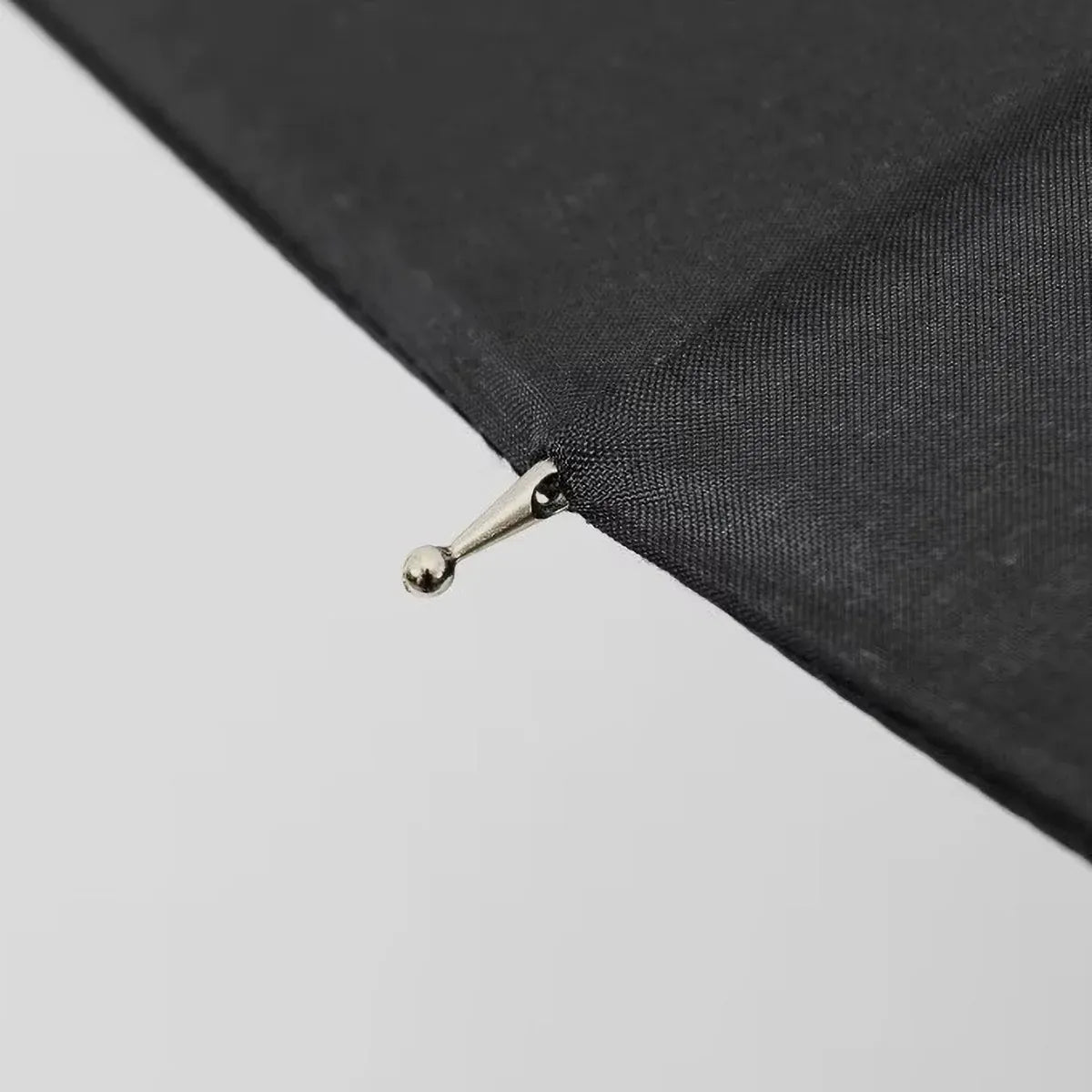 Close-up detail of the metal tip on the end of a canopy rib of the 24-rib umbrella.
