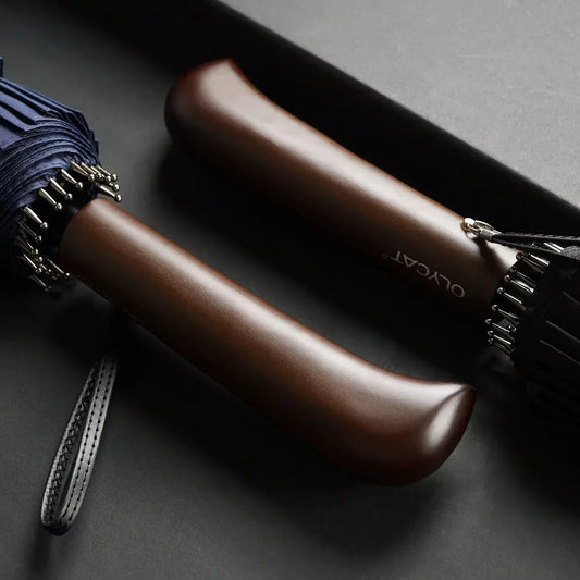 Close-up shot of the two ergonomic, natural wood handles for the black and navy 24-rib umbrellas.