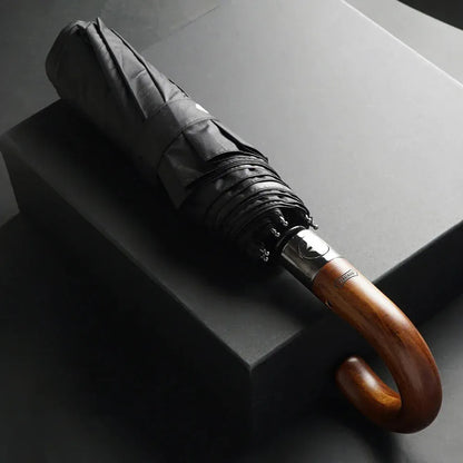 The 48-inch automatic folding umbrella with a wooden hook handle, shown closed in black.