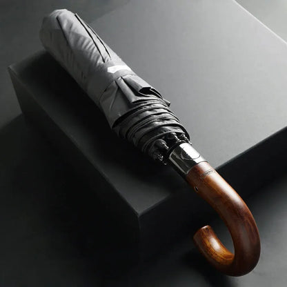 The 48-inch automatic folding umbrella with a wooden hook handle, shown closed in grey.