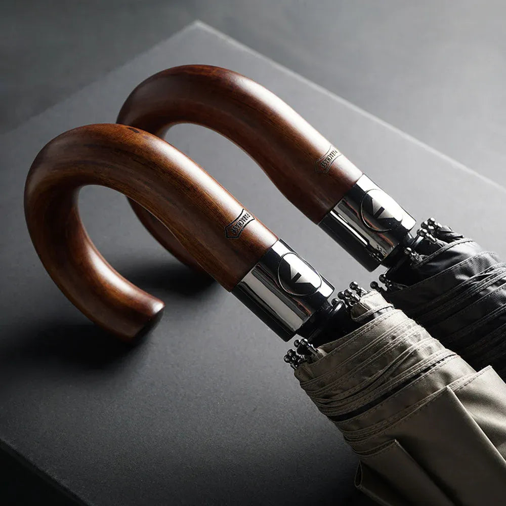 Close-up of two classic wooden hook handles, showing the rich grain and polished finish.