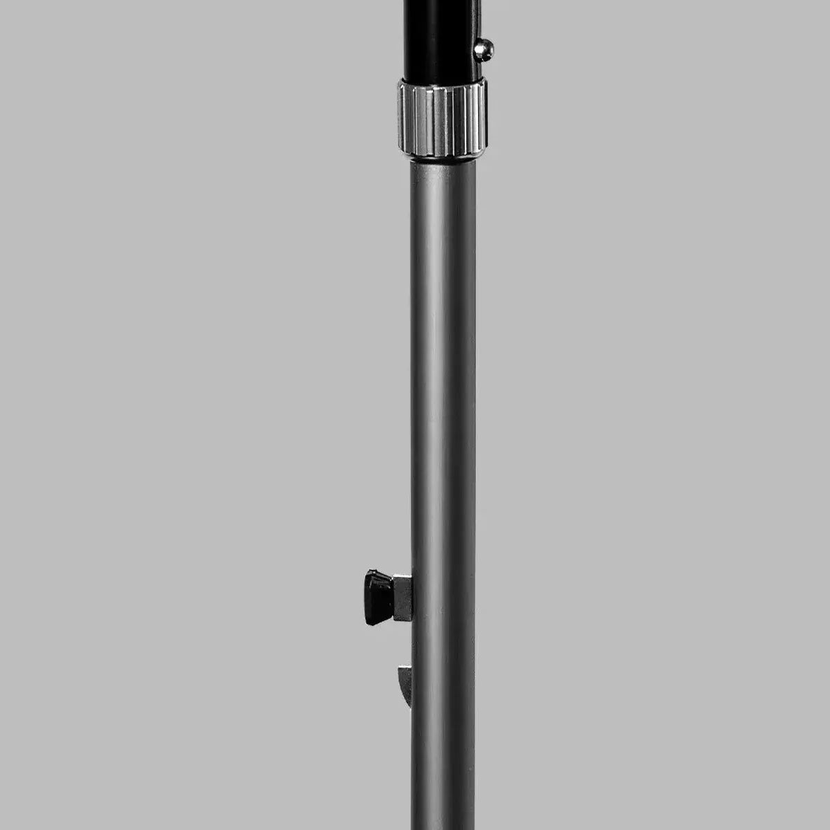 Close-up of the push-button mechanism on the aluminum shaft used for adjusting the height of the walking stick.