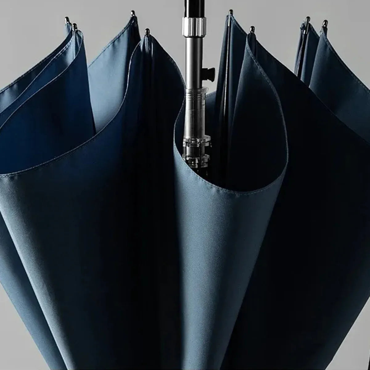 A detailed view of the semi-closed navy blue canopy, showing the durable pongee fabric and frame.