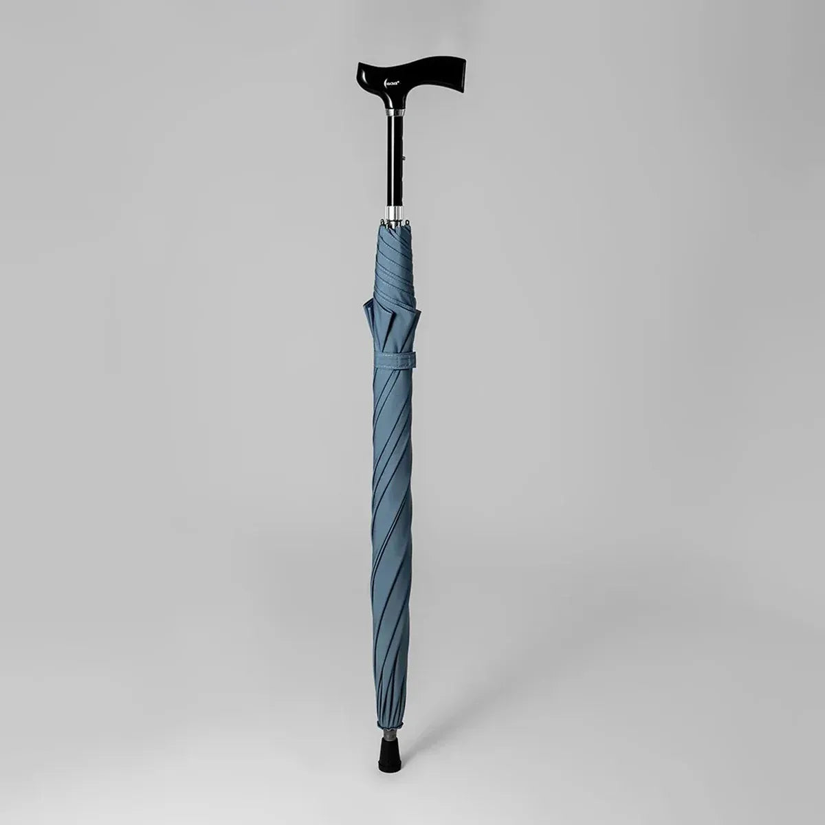 The light blue version of the adjustable walking stick umbrella shown closed without its sleeve.