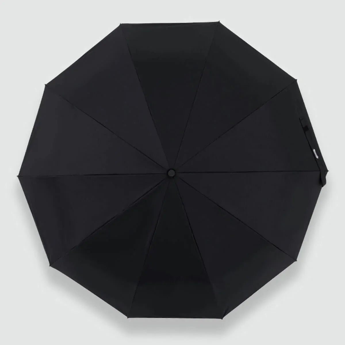 Top-down view of the open black canopy, showing the 10-panel design of the automatic umbrella.