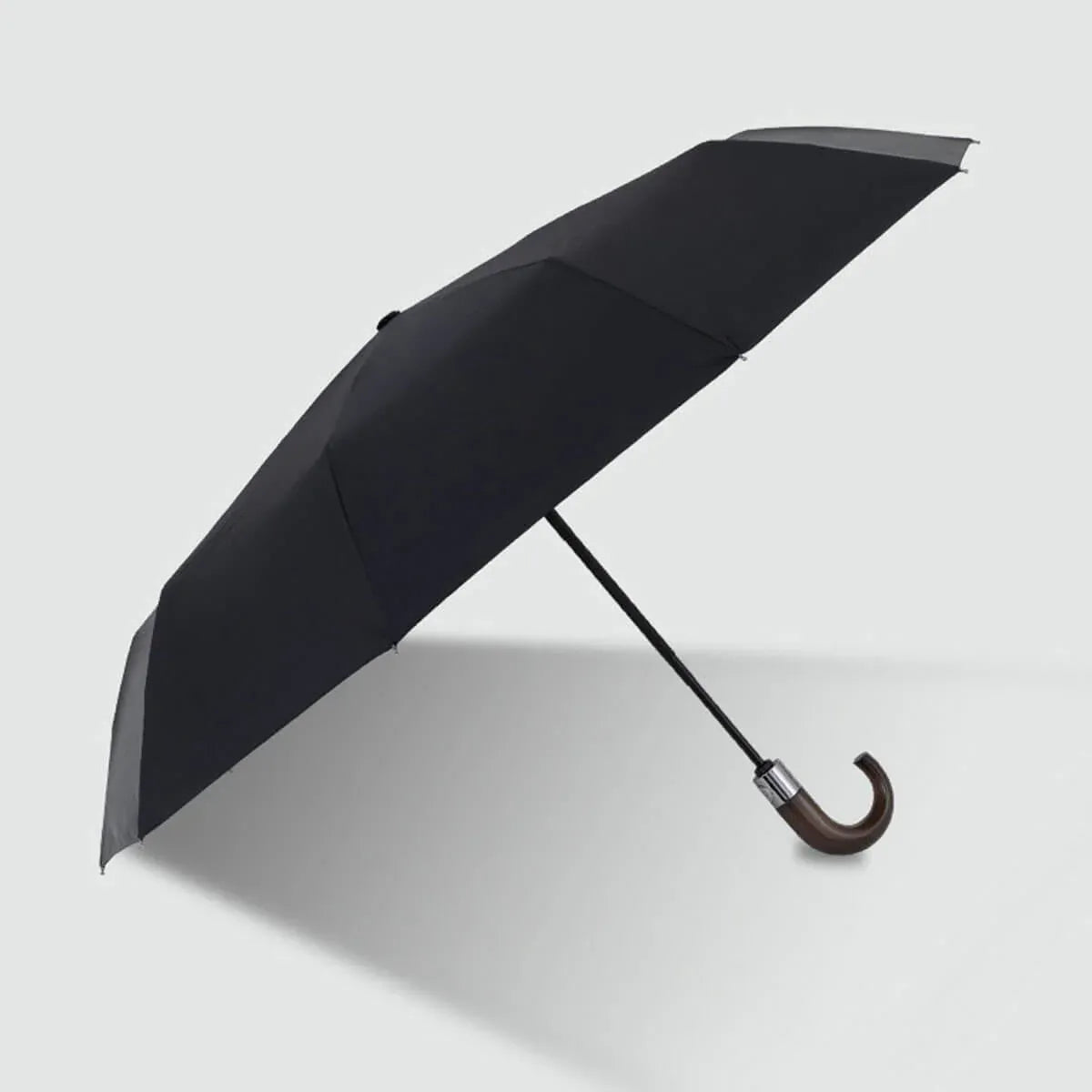Full view of the black 10-rib automatic folding umbrella with a natural wood hook handle.