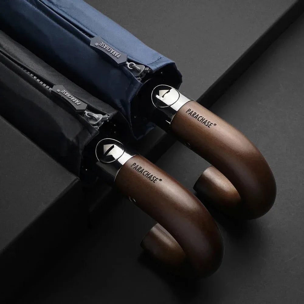 The wooden hook handles of the black and navy umbrellas, shown with their protective zippered sleeves.