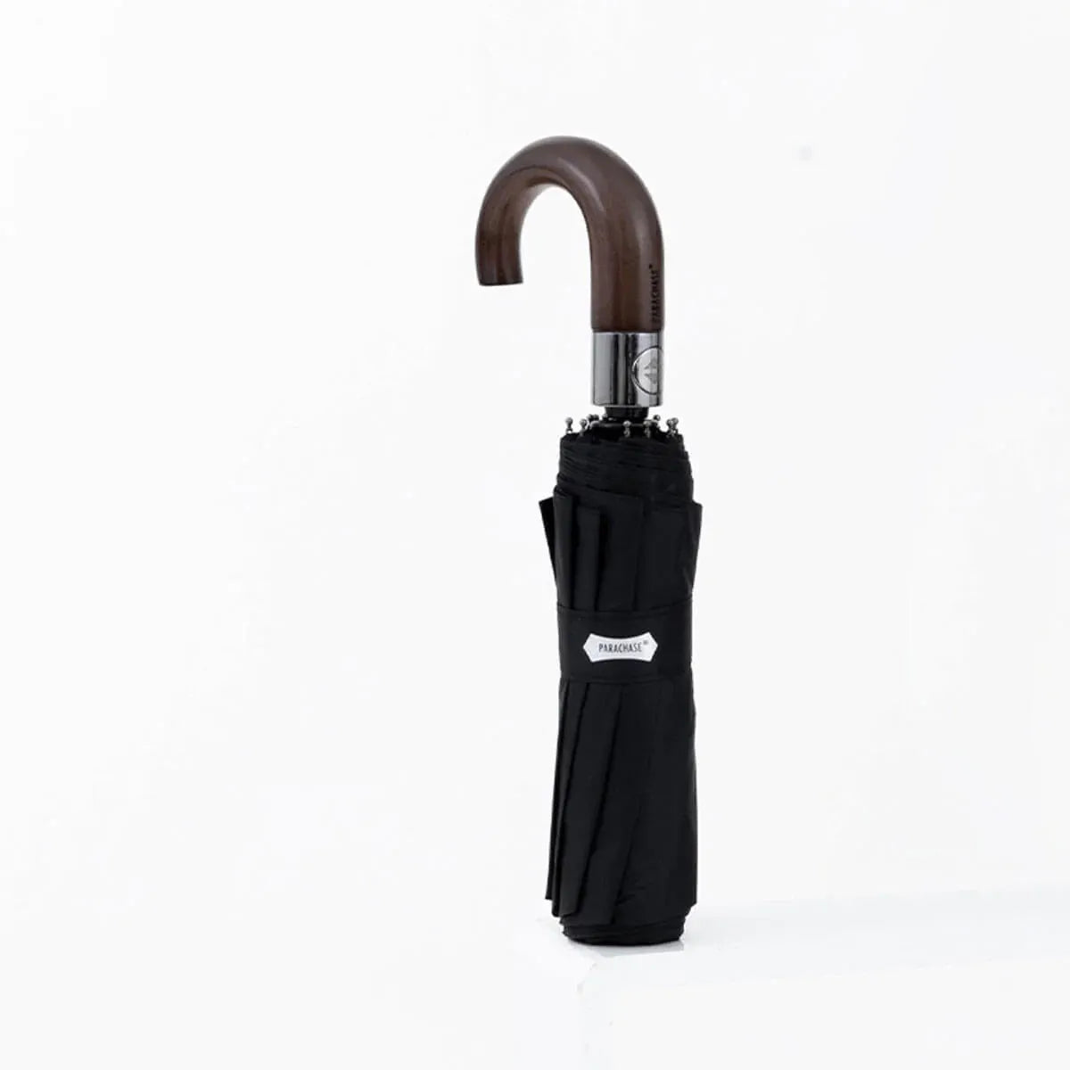 The automatic folding umbrella with a wooden hook handle, shown closed in a classic black color.