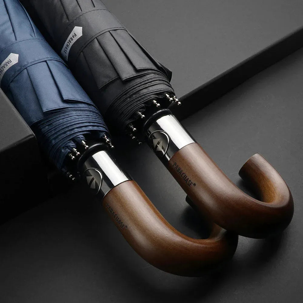 Detailed close-up of the natural wooden hook handles on the black and navy automatic umbrellas.
