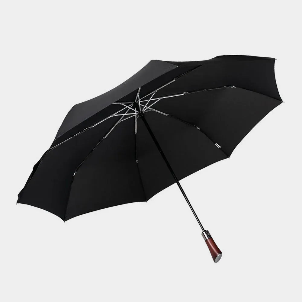 Full profile view of the open large automatic folding umbrella in black with a wood handle.