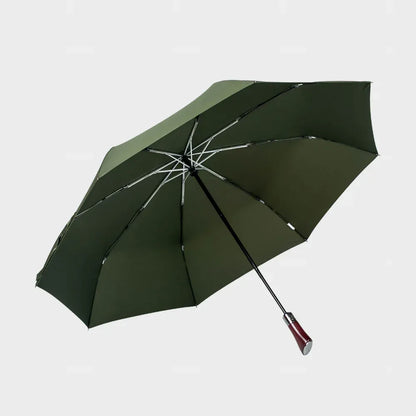 Full profile view of the open large automatic folding umbrella in green with a wood handle.