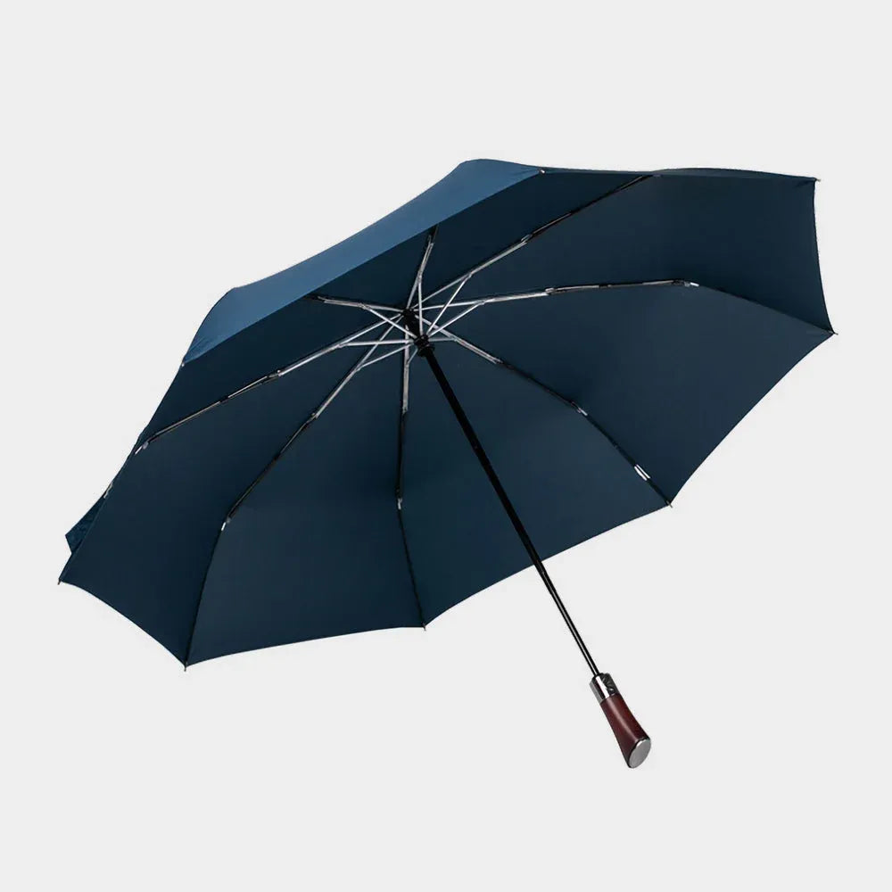 Full profile view of the open large automatic folding umbrella in navy blue with a wood handle.