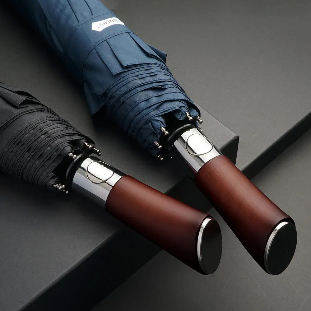 Close-up shot of the natural wood handles on the black and navy blue automatic folding umbrellas.