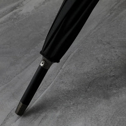 Detailed close-up of the polished metal tip (ferrule) at the end of the closed classic stick umbrella.