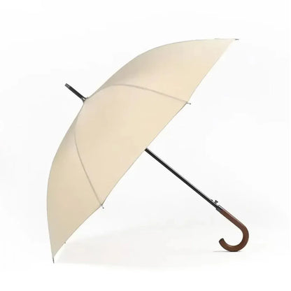The classic stick umbrella with a solid wooden crook handle, shown in an elegant beige-cream color.
