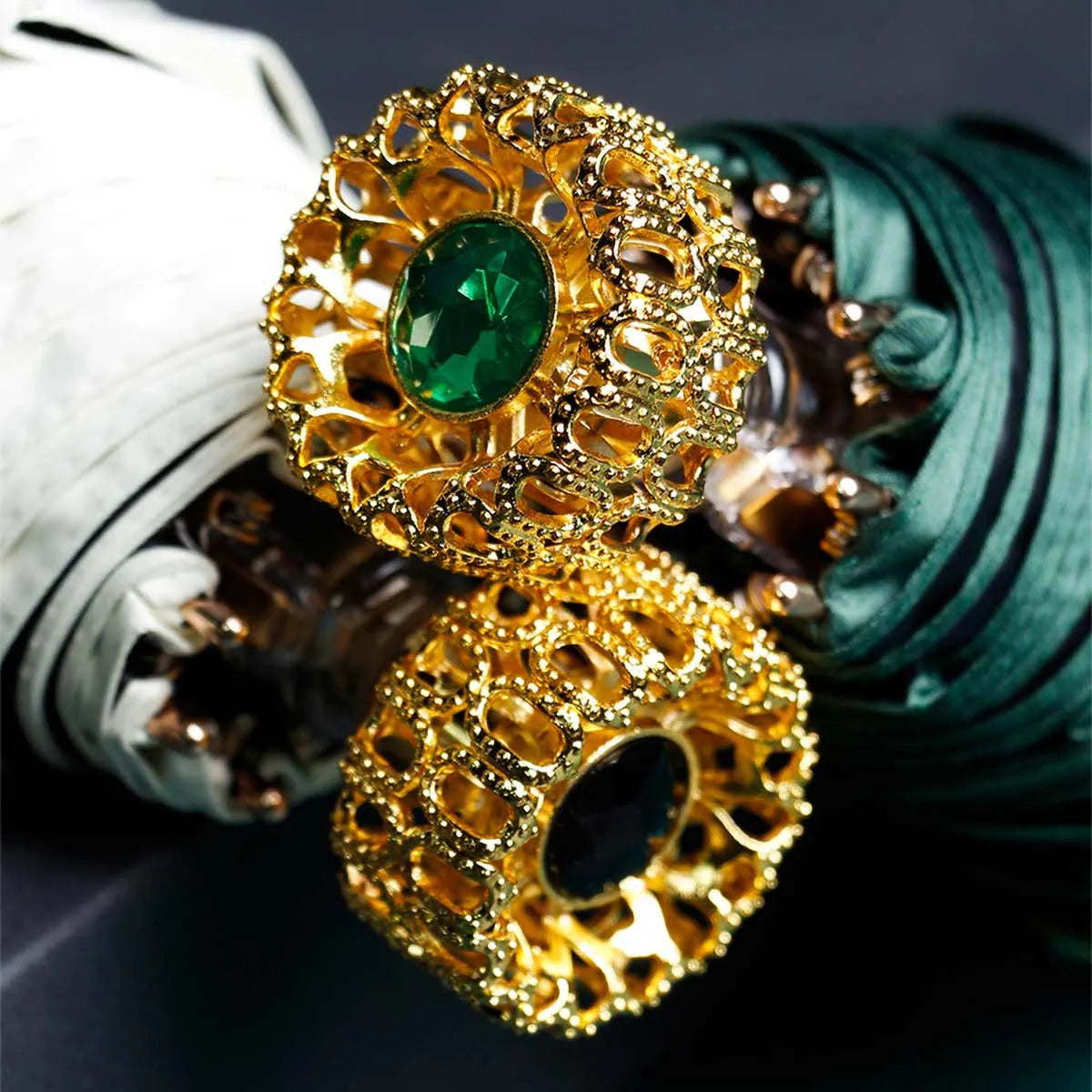 Detailed close-up of the ornate golden crystal handles in green and black stone variants.