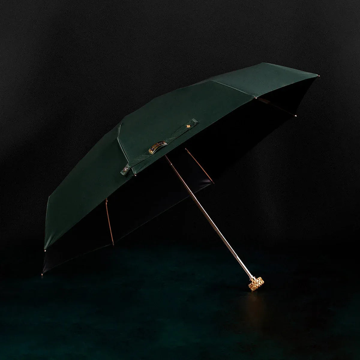 Full view of the open green compact luxury mini umbrella with its crystal handle.