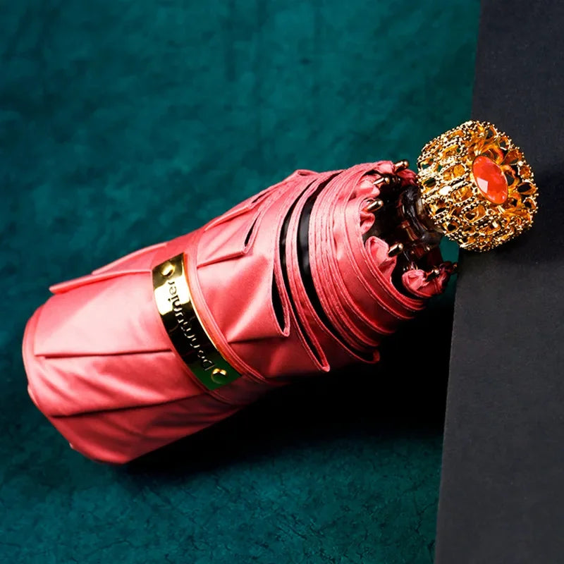 Compact luxury mini umbrella in pink, designed for fashionable and practical use.