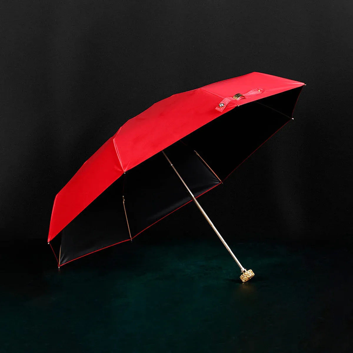 Full view of the open red compact luxury mini umbrella with its crystal handle.
