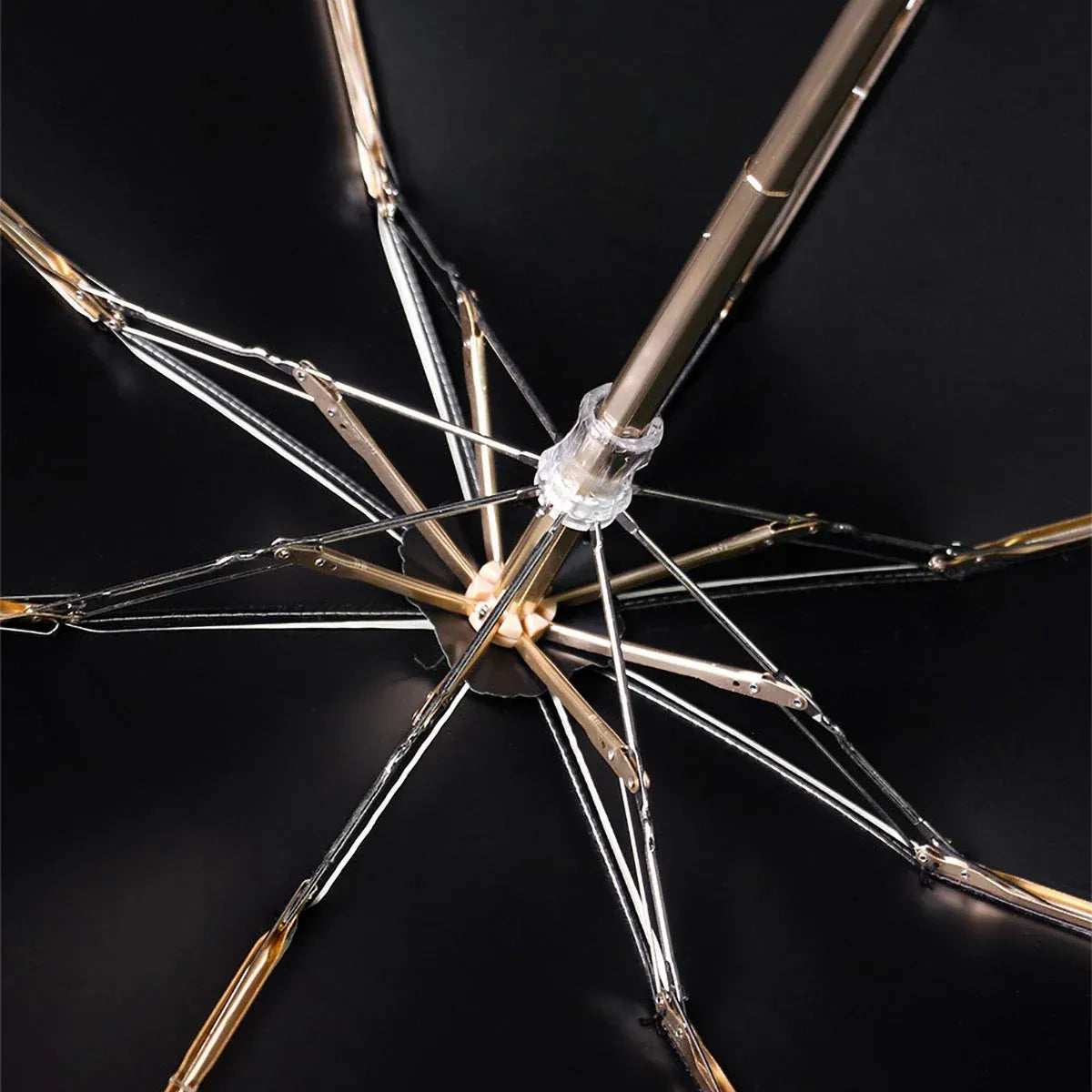 View from underneath the open canopy showing the golden aluminum frame structure.