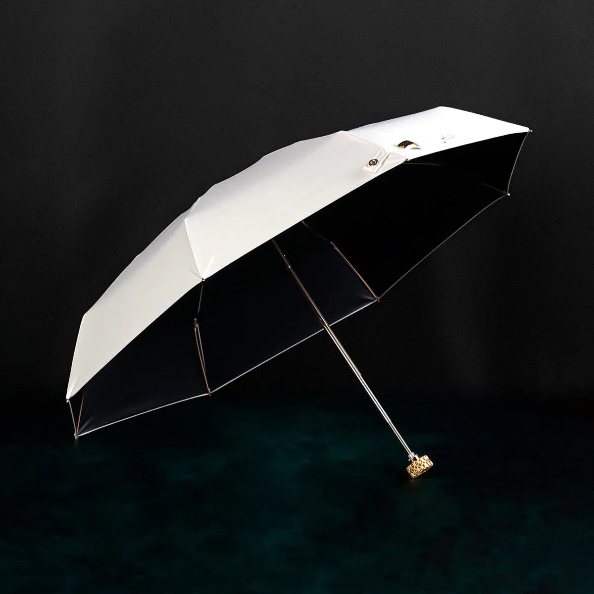 Full view of the open white compact luxury mini umbrella with its crystal handle.