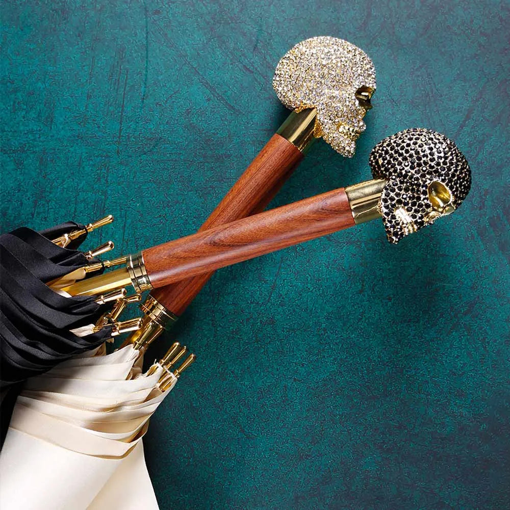 Top-down view comparing the jeweled skull handles of the black (black crystals) and white (white crystals) umbrellas.