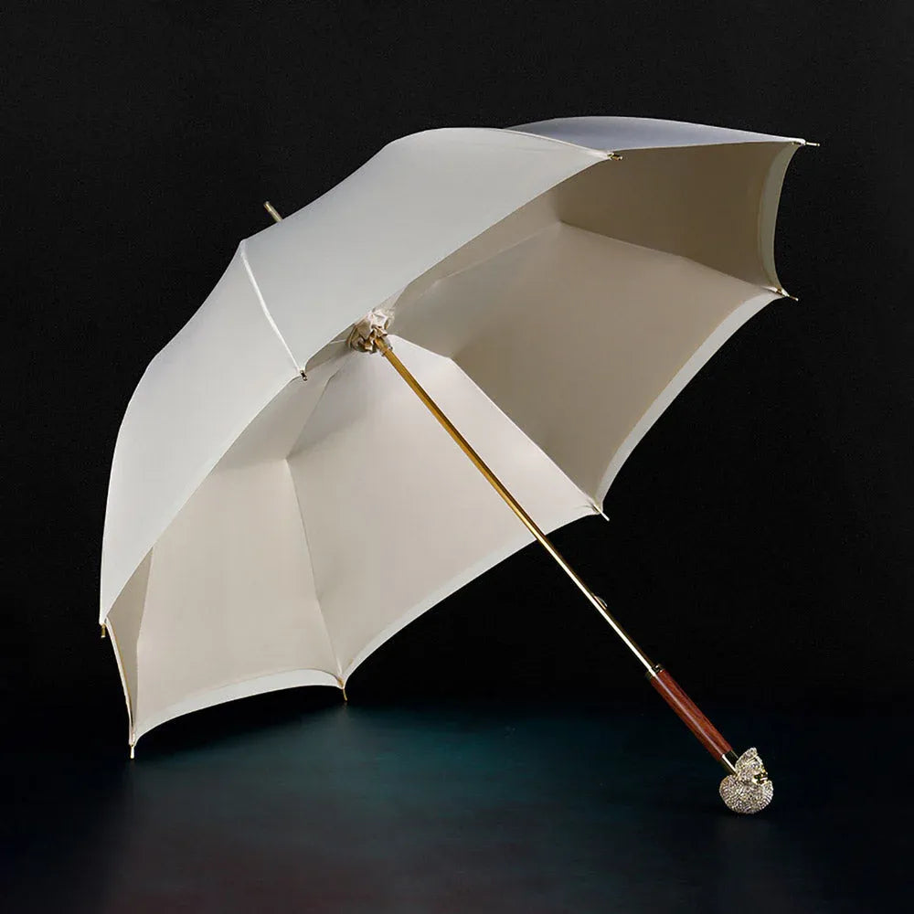 Full profile view of the open white Diamond Skull stick umbrella on a dark surface.