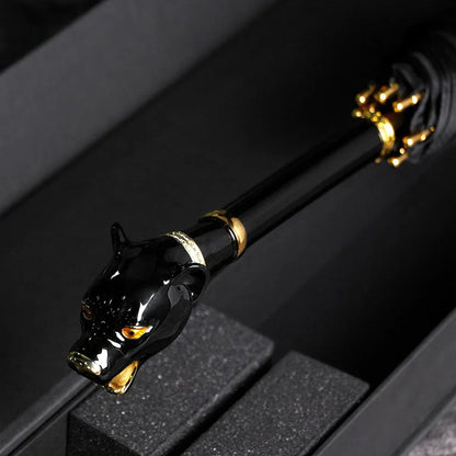 Detailed close-up of the luxurious black panther head handle with gold accents, resting in a box.