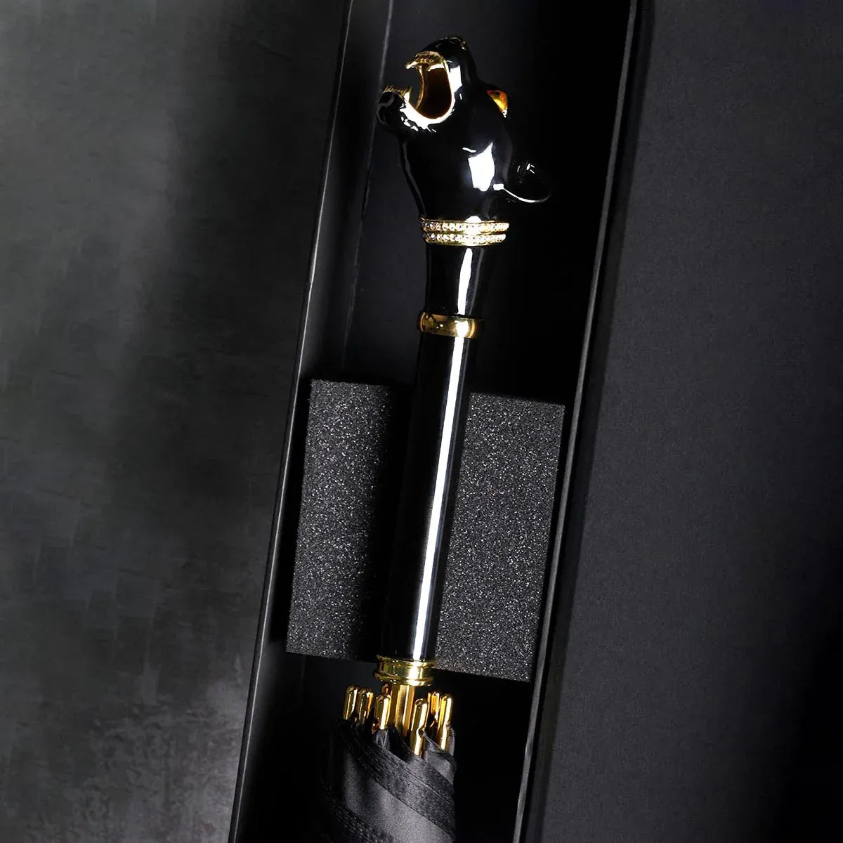 The elegant black panther handle umbrella presented inside its protective packaging.