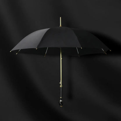 Front view of the open elegant black umbrella with gold accents and panther head handle.