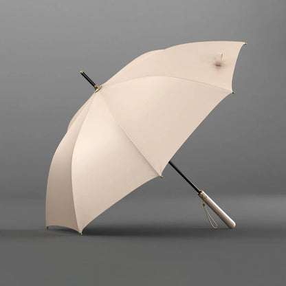 Angled profile view of the open beige elegant long handle umbrella.