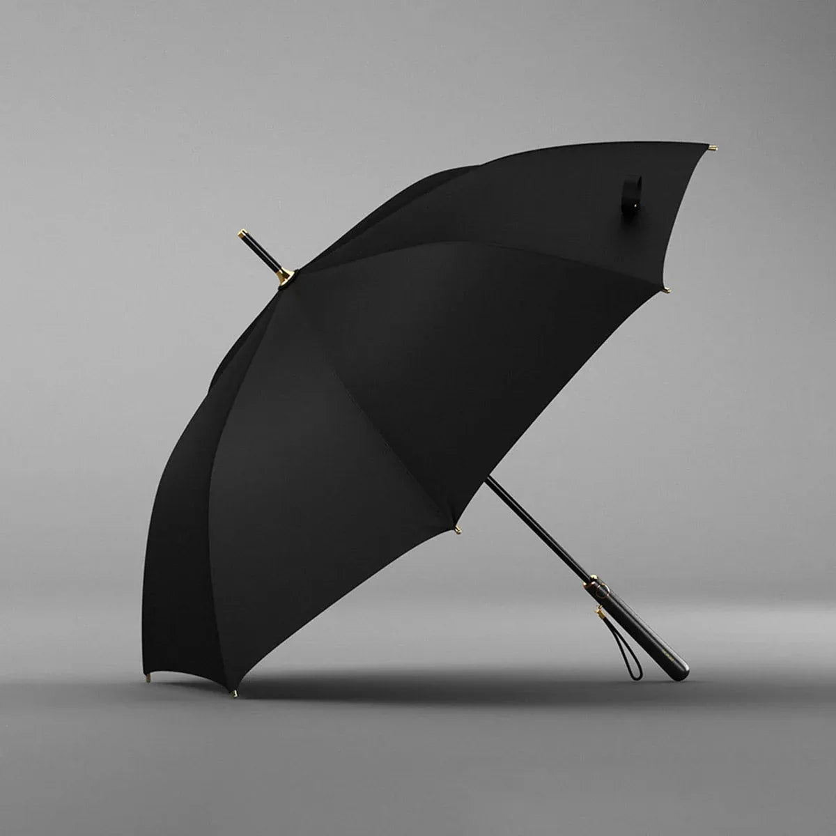 Angled profile view of the open black elegant long handle umbrella.