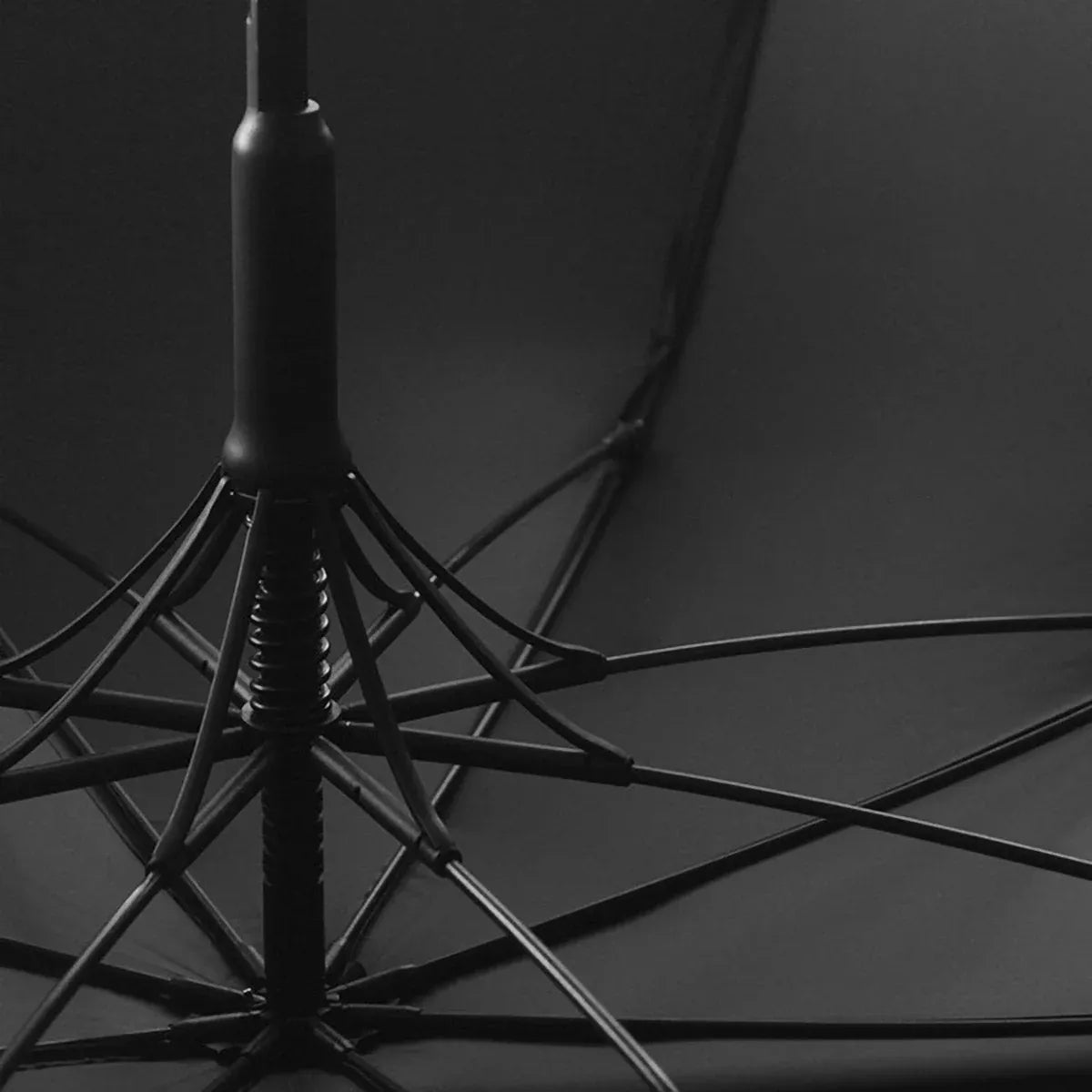 View from underneath the open black canopy showing the 8-rib fiberglass frame structure.