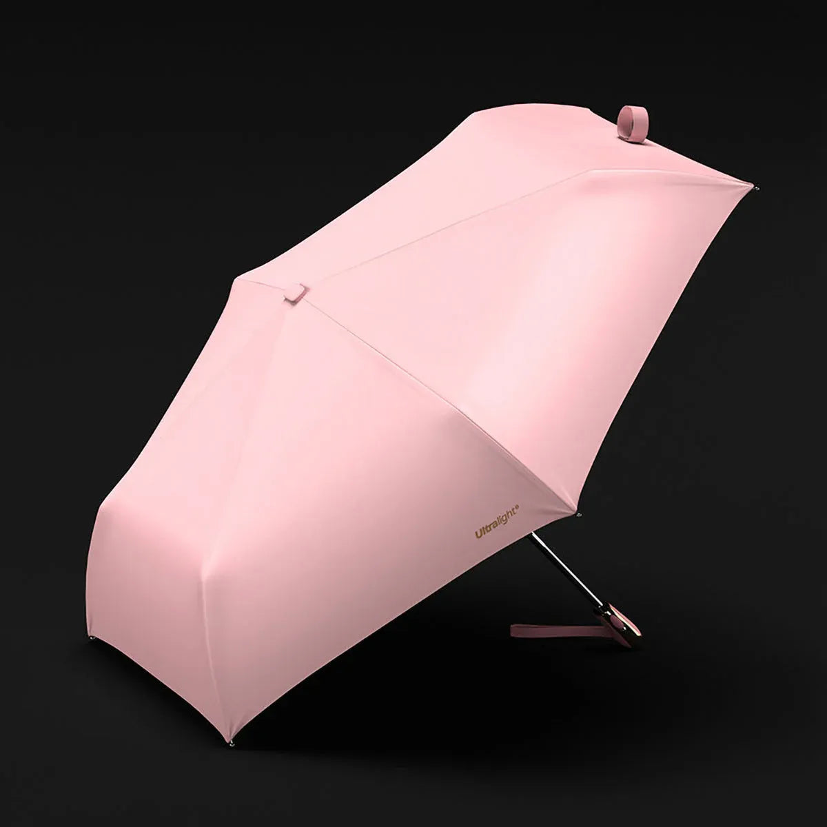 Angled view of the open pink canopy on the elegant, ultralight travel umbrella.