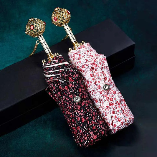 The dark and light floral pattern flower folding umbrellas shown closed side-by-side.
