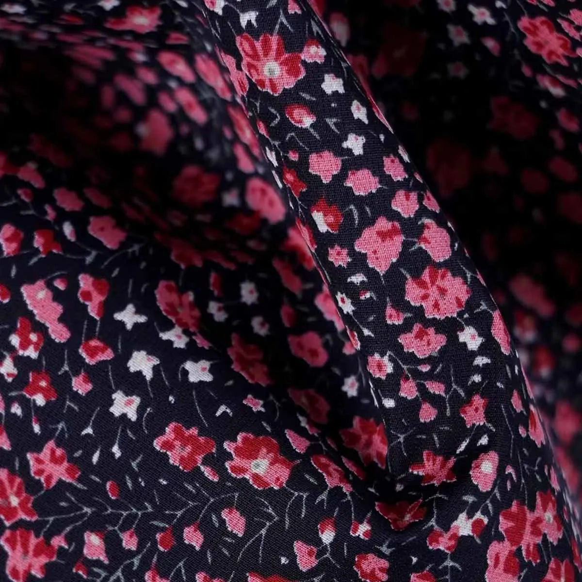Close-up texture shot of the premium double-layer fabric with the dark floral pattern.