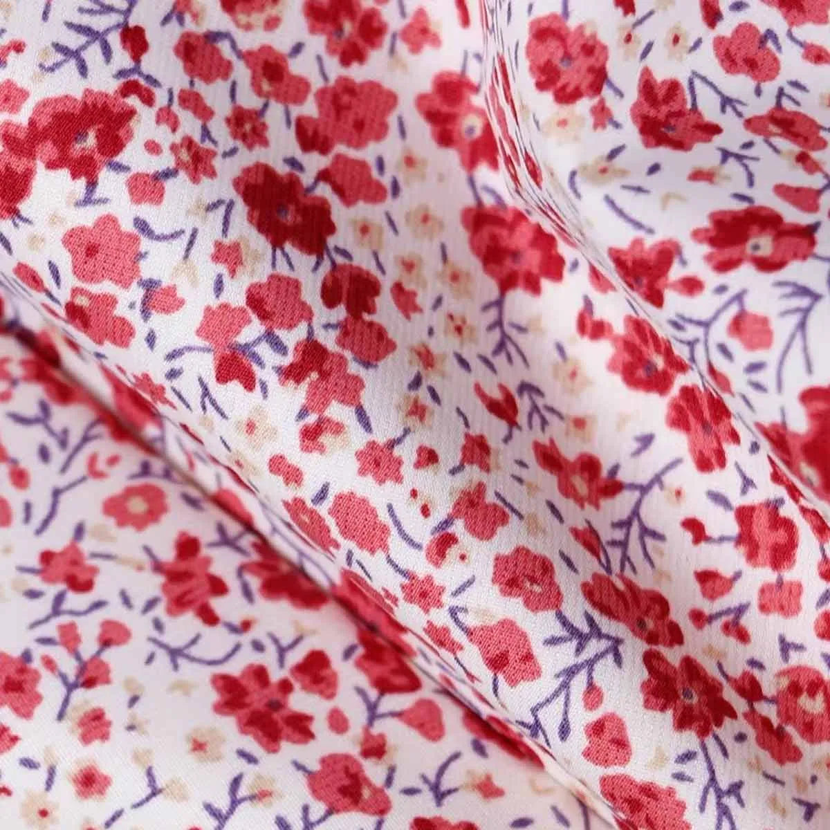Close-up texture shot of the premium double-layer fabric with the light floral pattern.