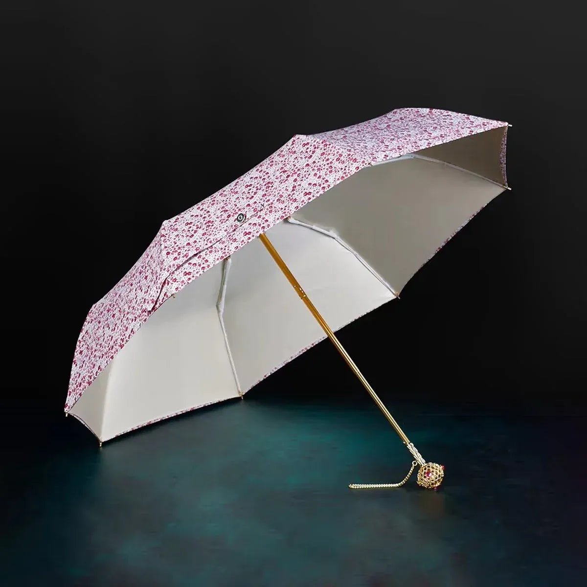 Full view of the open flower folding umbrella in the light floral pattern with jeweled handle.