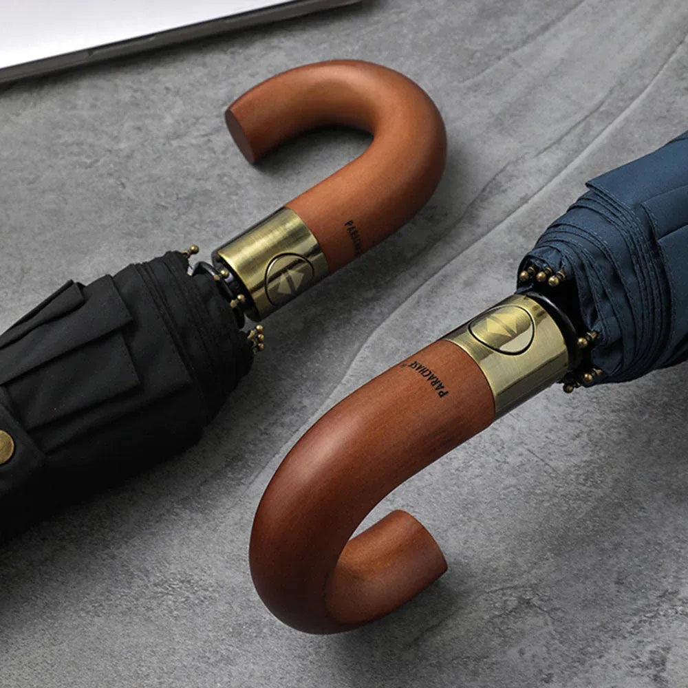 Close-up angle of the elegant natural wood J-handles on the black and navy umbrellas.
